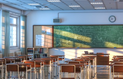 interior of a school classroom with wooden desks and chairs.